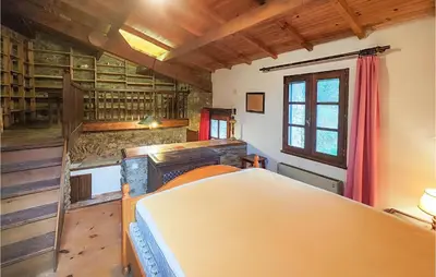 a bedroom with a bed in a room with wooden ceilings at Cozy Home In Olargues With Kitchen in Olargues