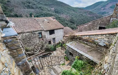 an aerial view of an old building with mountains in the background at Cozy Home In Olargues With Kitchen in Olargues