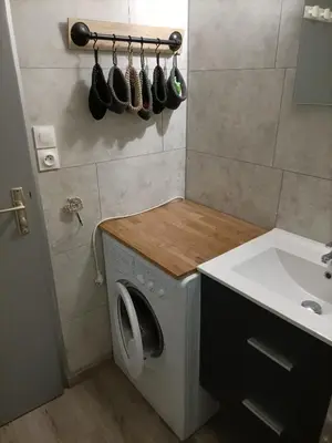 a washing machine in a bathroom next to a sink at Le clin d'oeil sur le port. in Gruissan