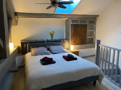 a bedroom with a bed with two towels on it at Dupleix au Fil du Canal in Narbonne