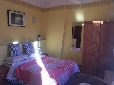 a bedroom with a bed and a dresser at Maison Ventenac village house in Ventenac en Minervois