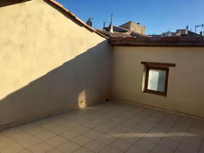 a balcony of a house with a small window at Maison Ventenac village house in Ventenac en Minervois