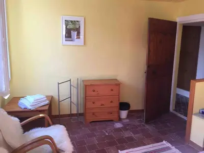 a living room with a wooden dresser and a dresser and a dresser at Maison Ventenac village house in Ventenac en Minervois