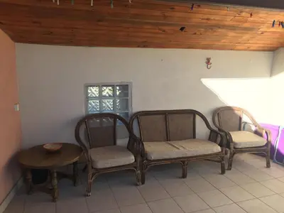 a room with two chairs and a table and a window at Maison Ventenac village house in Ventenac en Minervois