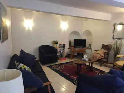a living room with a couch and a table at Maison Ventenac village house in Ventenac en Minervois