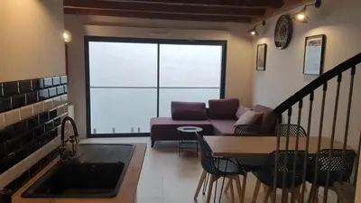 a living room with a couch and a table at SUPERBE T3 AU COEUR DU CENTRE VILLE in Narbonne