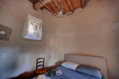a bedroom with a bed and a chandelier at Château de Mézerville in Mézerville
