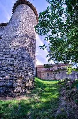 a tall stone tower sitting next to a building at Château de Mézerville in Mézerville