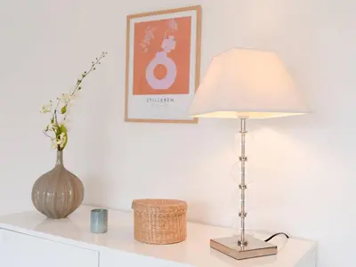 a table with a lamp and a vase on it at Pavillon lumineux avec terrasse, à 1 km de la plage – 2 pièces, 1 chambre, barbecue, Wi-Fi - FR-1-409A-3 in Gruissan