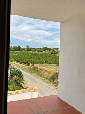 a view from a window of a road and a field at Gite de charme à 10 min de Narbonne in Moussan