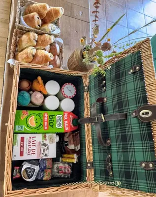 an open suitcase filled with different types of food at Gite de charme à 10 min de Narbonne in Moussan