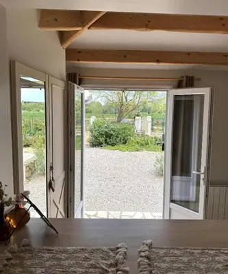 an open door with a view of a yard at Gite de charme à 10 min de Narbonne in Moussan