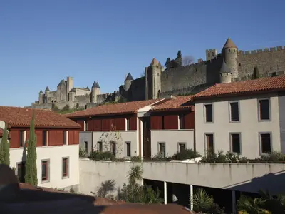 a group of buildings with a castle in the background at res La Barbacane, Carcassonne, studio for 2 people in Carcassonne