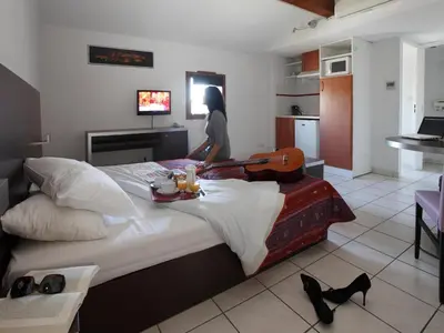 a room with a bed with a woman holding a gun at Res La Barbacane, Carcassonne, apartment for 4 pers in Carcassonne