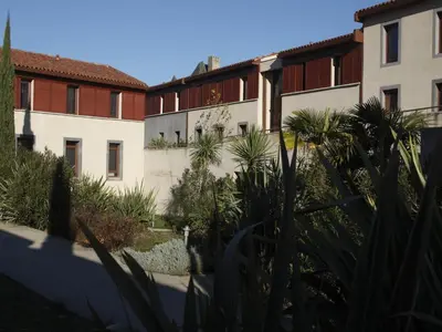 a row of buildings with plants in the foreground at Res La Barbacane, Carcassonne, apartment for 4 pers in Carcassonne