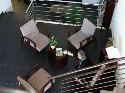a man sitting in a waiting room with two chairs at Res La Barbacane, Carcassonne, apartment for 4 pers in Carcassonne