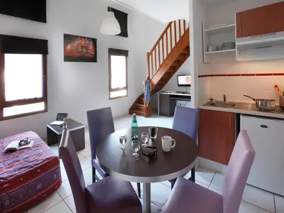 a kitchen and dining room with a table and chairs at Res La Barbacane, Carcassonne, apartment for 4 pers in Carcassonne