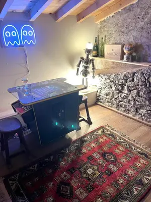 a room with a table and a rug on the floor at La Maison de Mama C: Charming french village home in Sainte-Colombe-sur-lʼHers
