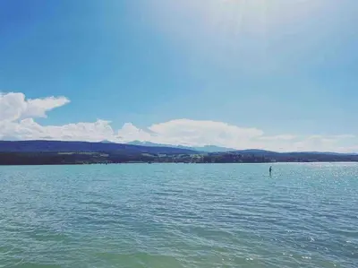 a large body of water with a person in the water at La Maison de Mama C: Charming french village home in Sainte-Colombe-sur-lʼHers
