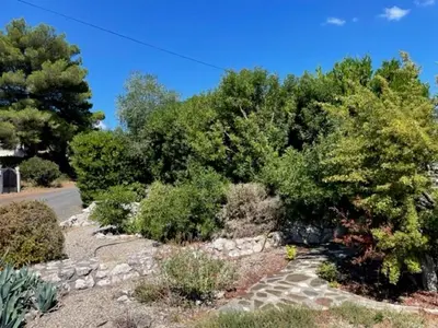 a garden with trees and a stone path at Modern Comfort in Minervois in Pouzols-Minervois