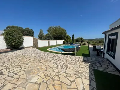 a stone patio with a swimming pool in a yard at Modern Comfort in Minervois in Pouzols-Minervois