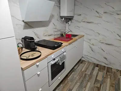 a kitchen with white cabinets and a counter top at Marina 4 ou 8 ou 9 in Narbonne