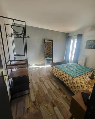 a bedroom with a bed and a wooden floor at Marina 4 ou 8 ou 9 in Narbonne