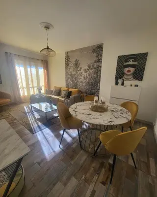 a living room with a table and a couch at Marina 4 ou 8 ou 9 in Narbonne