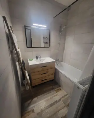 a bathroom with a sink and a tub and a mirror at Marina 4 ou 8 ou 9 in Narbonne