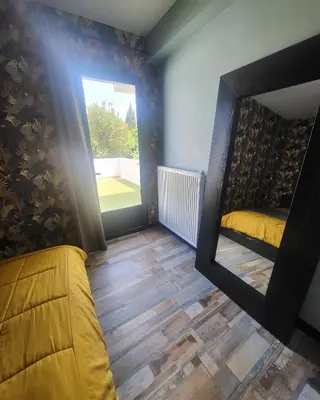 a room with a mirror and a bed and a window at Marina 4 ou 8 ou 9 in Narbonne