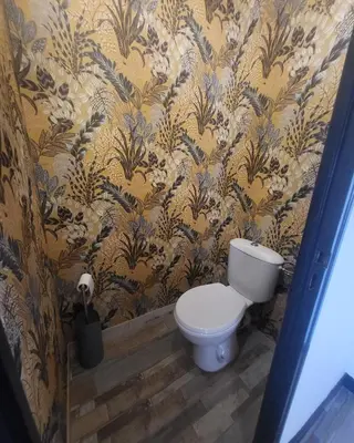 a bathroom with a toilet and floral wallpaper at Marina 4 ou 8 ou 9 in Narbonne