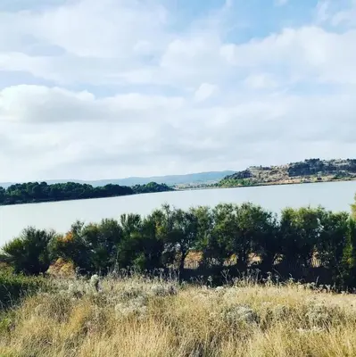 a view of a lake from a field at Mobilhome « Candice » in Sigean