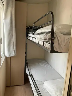 a small room with two bunk beds in it at Mobilhome « Candice » in Sigean