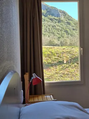 a bedroom with a window with a view of a field at Evasion en pays Cathare in Quillan