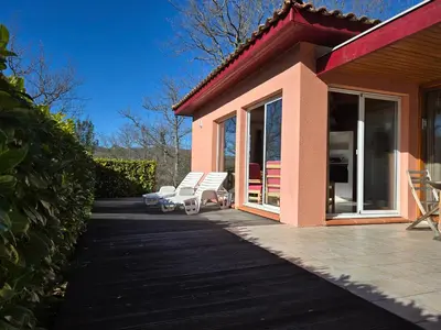 a patio with two white chairs and a house at Evasion en pays Cathare in Quillan