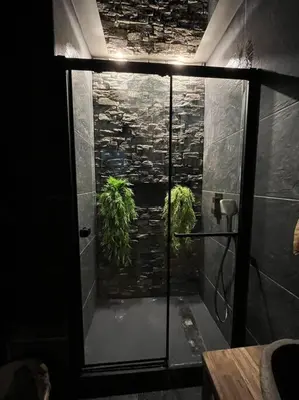 a shower with a glass door in a bathroom at Appartement Haussmannien a 200m des Halles. in Narbonne