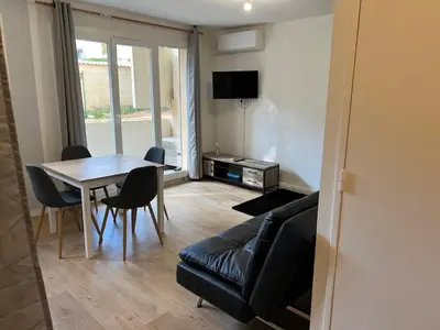 a living room with a couch and a table at A Narbonne studio quartier Horte neuve in Narbonne