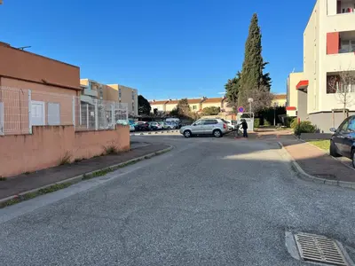 an empty street with cars parked on the side of the road at A Narbonne studio quartier Horte neuve in Narbonne