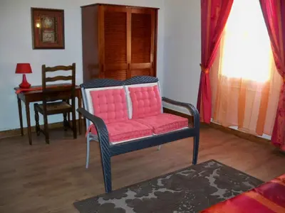 a living room with a pink chair and a table at Marrakech Guest Room in the heart of the vineyard in Badens