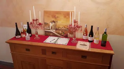 a table with a bunch of bottles of wine on it at Marrakech Guest Room in the heart of the vineyard in Badens