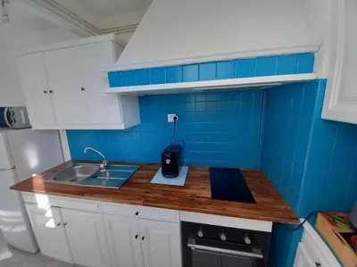 a small kitchen with a sink and blue tiles at Appart 2/4 pers proche centre avec Balcon, Parking in Narbonne