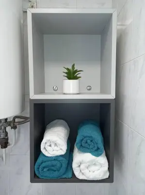 a towel rack with towels in a bathroom at Appart 2/4 pers proche centre avec Balcon, Parking in Narbonne