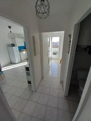 a view of a kitchen and a hallway at Appart 2/4 pers proche centre avec Balcon, Parking in Narbonne