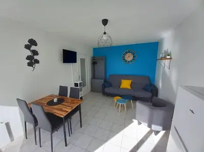 a living room with a couch and a table at Appart 2/4 pers proche centre avec Balcon, Parking in Narbonne