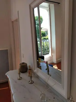 a bathroom with a large mirror on a table at Appartement avec balcon, bord du canal, Wifi. in Narbonne