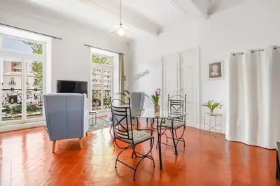 a living room with a dining room table and chairs at Appartement avec balcon, bord du canal, Wifi. in Narbonne