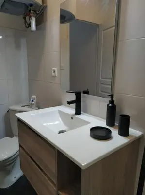 a bathroom with a sink and a toilet at Appartement avec balcon, bord du canal, Wifi. in Narbonne