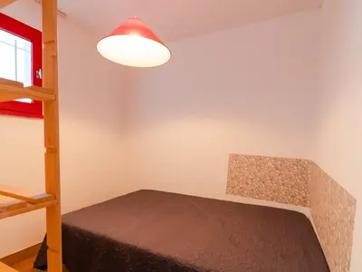 a bedroom with a bunk bed and a lamp at T2 avec Piscine à Gruissan - Proche Plage et Commerces - FR-1-409A-14 in Gruissan