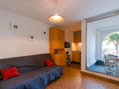 a living room with a couch and a large window at T2 avec Piscine à Gruissan - Proche Plage et Commerces - FR-1-409A-14 in Gruissan