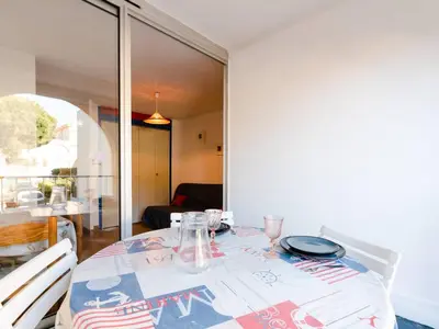 a dining room table with a table cloth on it at T2 avec Piscine à Gruissan - Proche Plage et Commerces - FR-1-409A-14 in Gruissan